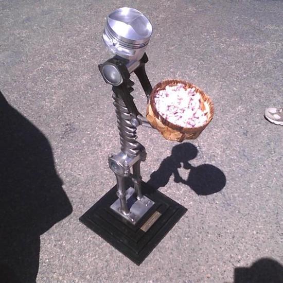 A piston statue holding mints at the Cavalier Car Show