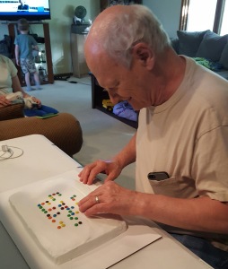 Jim reading a braille birthday cake